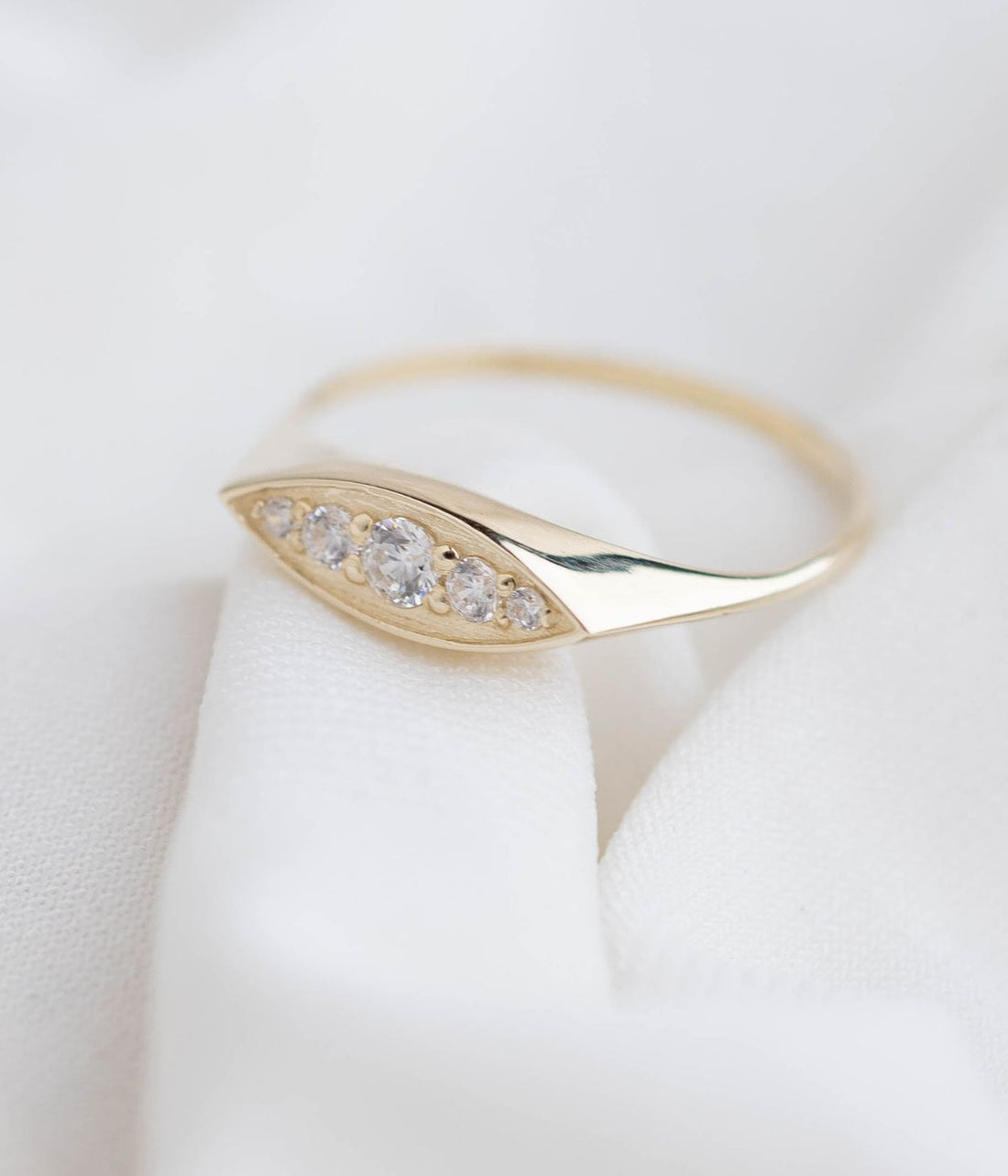 טבעת זהב 14K אובלית מוגבהת, משובצת יהלומים או זירקונים בשלושה גדלים שונים בעיצוב קלאסי ויוקרתי.