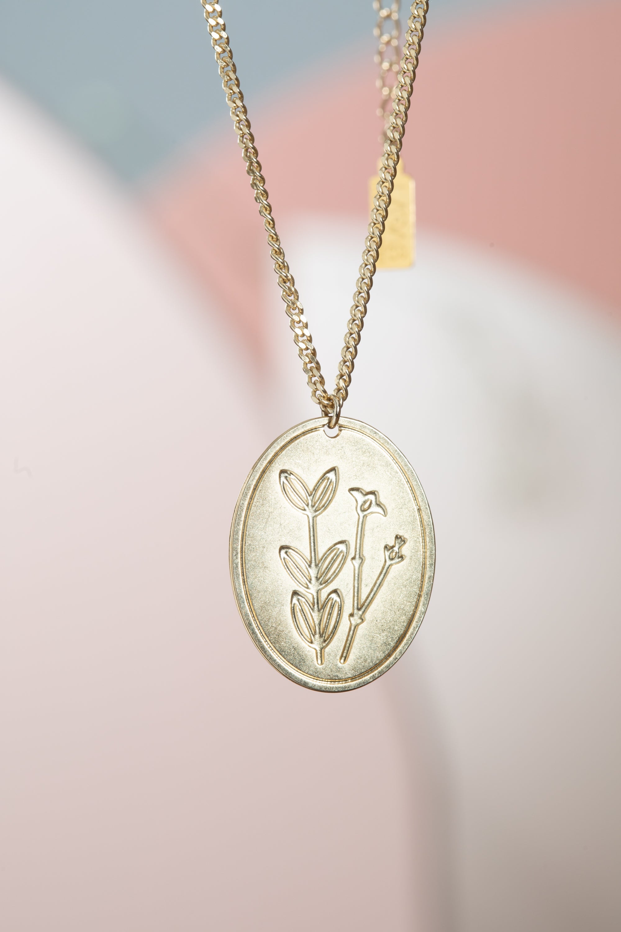 שרשרת פרח בר תליון אובל ציפוי זהב עם חריטת מילה מבית הדס קוקה תכשיטים – עיצוב מיוחד עם משמעות אישית