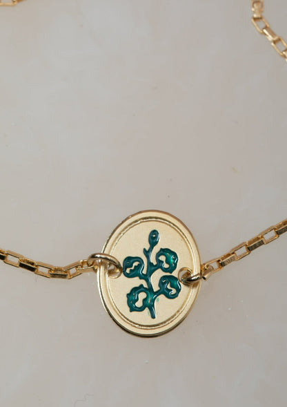 צמיד כותנה עם חריטה של פרח כותנה בצבע טורקיז וחריטת המילים &